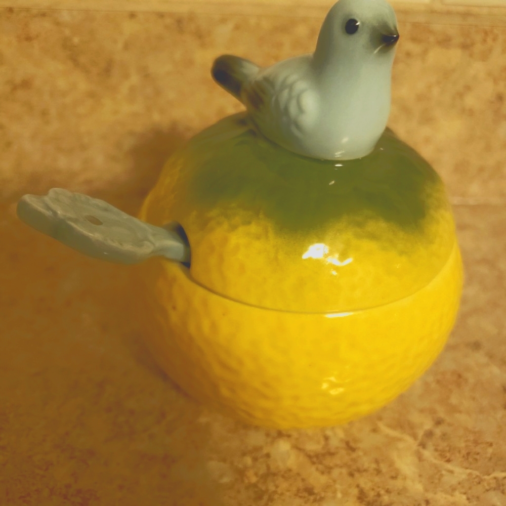 Lemon with blue bird ceramic sugar bowl with spoon.